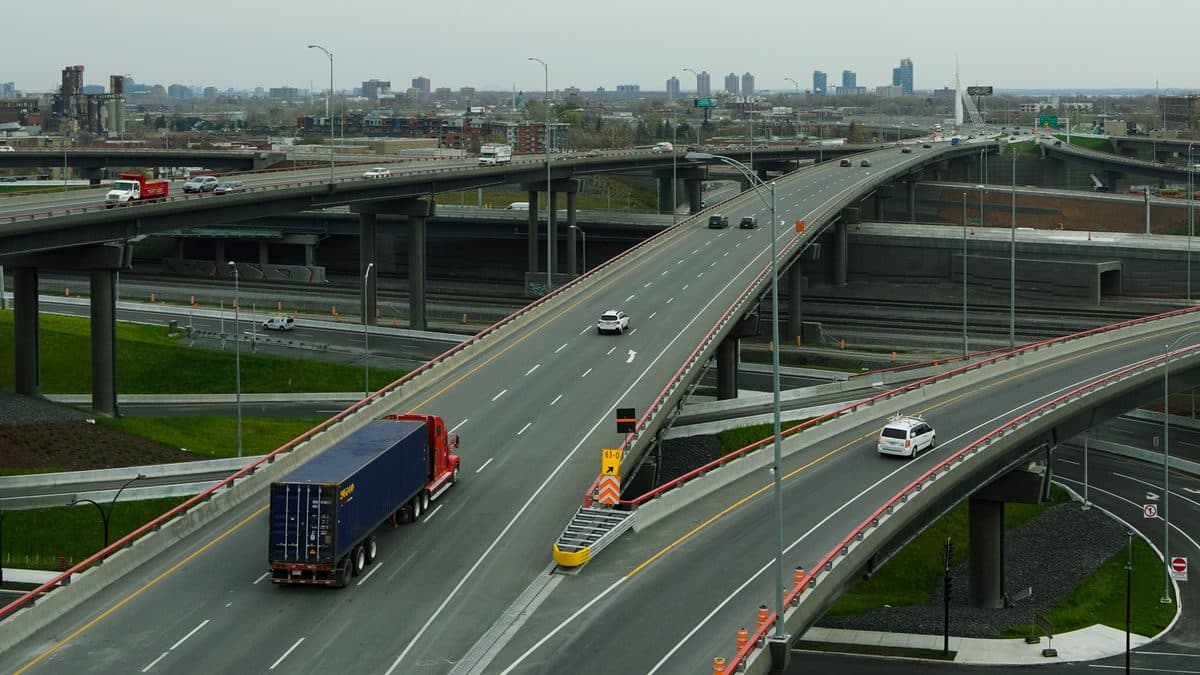 A tractor-trailer crossing a multi-level highway interchange