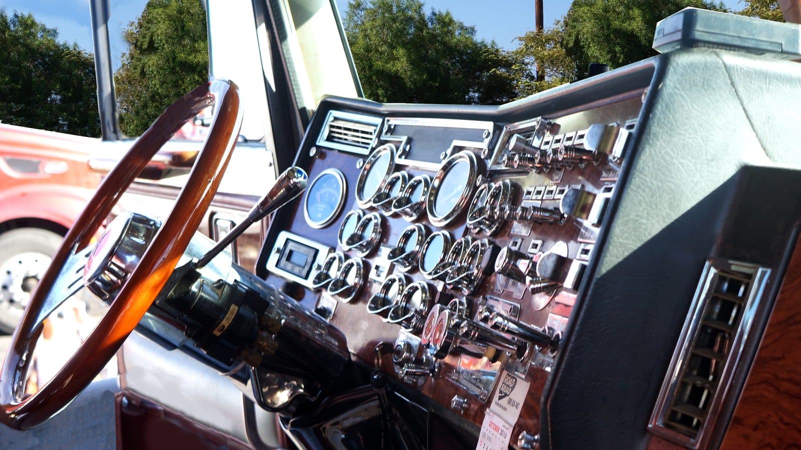 The instrument panel and steering wheel inside a truck cab